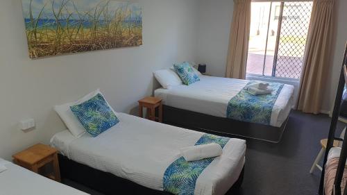 A bed or beds in a room at Aqua Villa Holiday Apartments