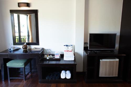 a living room with a table and a tv at Klong Prao Resort - SHA Extra Plus in Ko Chang