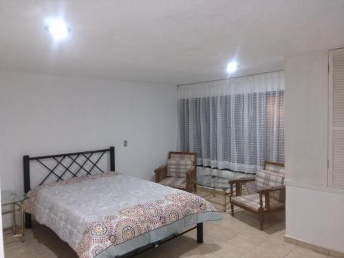 Llit o llits en una habitació de Casa de Irma para visitar la ciudad o de negocios