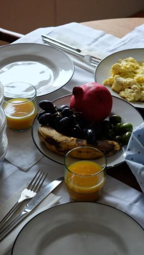 a table with plates of breakfast food on it at Flattered to be in Porto in Porto