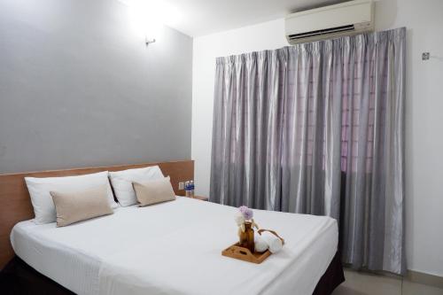 Postel nebo postele na pokoji v ubytování Indah Garden Hotel