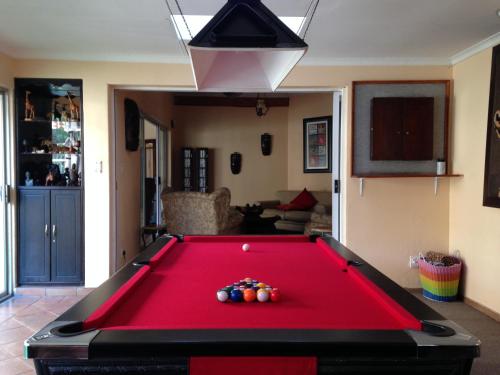 a red pool table in a living room at Ipe Tombe Guest Lodge - Midrand in Midrand