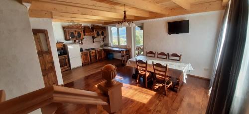 a kitchen and dining room with a table and chairs at PERFECT in Yaremche