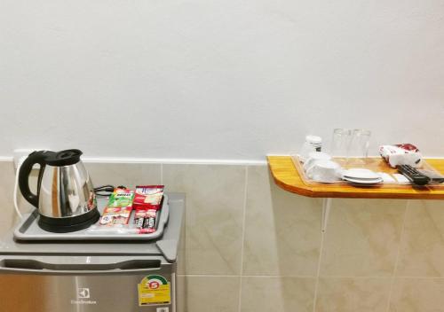 a kitchen with a stove and a wooden counter top at ลิตเติ้ล ฮิลล์ สัตหีบ รีสอร์ท ( Little Hill Sattahip Resort ) in Sattahip
