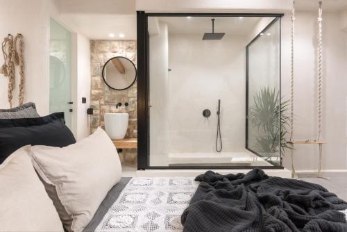 a bathroom with a shower and a bed in a room at Emery Hotel in Naxos Chora