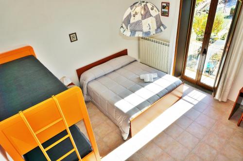 a small bedroom with a bed and a window at Agriturismo Costa San Bernardo in Vaglio di Basilicata