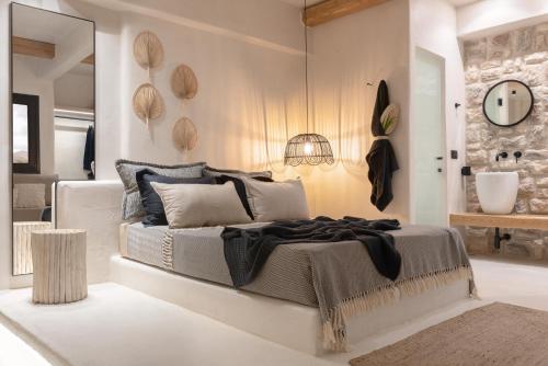 a bedroom with a large bed and a mirror at Emery Hotel in Naxos Chora