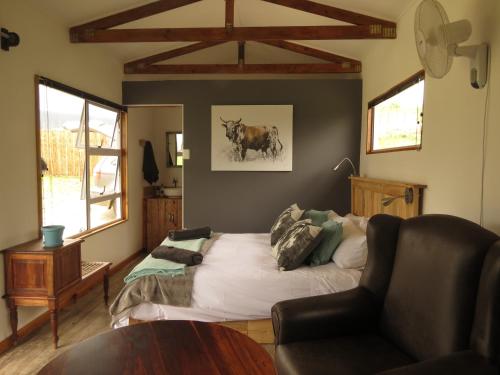 a living room with a bed and a couch at Mysthill Eco Cottage in Molen Drift