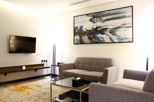 a living room with a couch and a tv at Iris Boutique Taif Heart in Taif