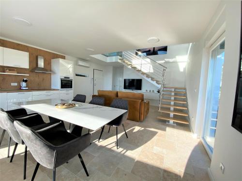 a kitchen and living room with a table and chairs at Villa M - Your business & holiday apartment in Sibenik in Šibenik