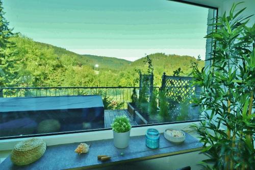 a window with a view of a mountain at Fewo Haus Bellevue - inkl. MeineCard+ in Willingen