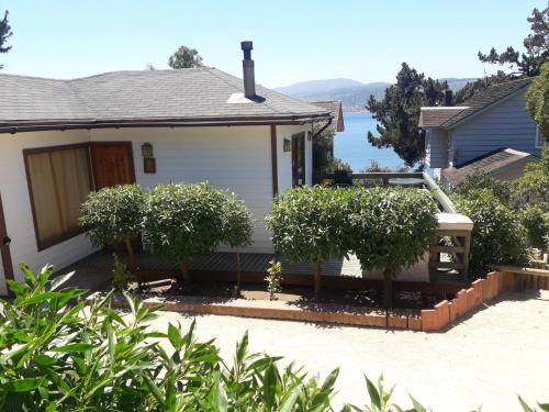 a house with trees in the front yard at AmbienteMar Cabañas in Papudo