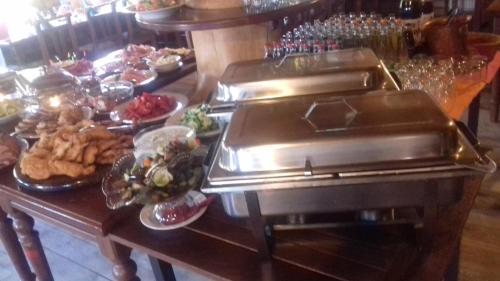 a buffet line with plates of food on a table at Koliba Valaška in Trojanovice