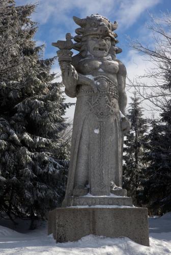 a statue of an angel standing in the snow at Koliba Valaška in Trojanovice