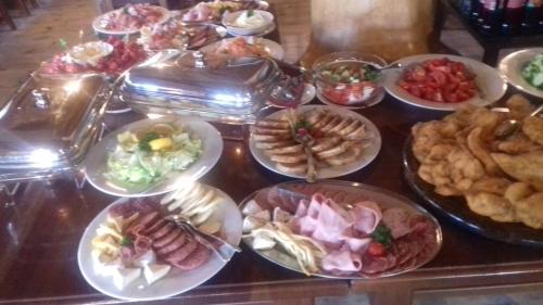 a table with many plates of food on it at Koliba Valaška in Trojanovice