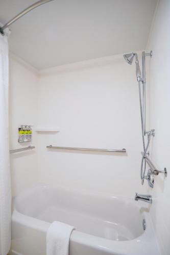 a white bathroom with a tub and a sink at Holiday Inn Express Prescott by IHG in Prescott