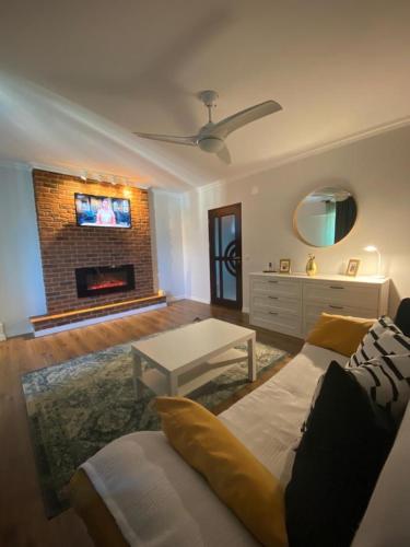 a living room with a couch and a fireplace at Apartament Claudia -self check-in in Brăila