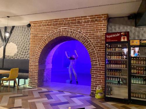 a man jumping in a brick wall in a wine store at Sinay Hotel & Restaurant in Chechel'nyk