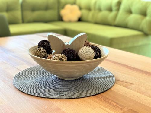 a bowl of balls of yarn sitting on a table at Villa M - Your business & holiday apartment in Sibenik in Šibenik