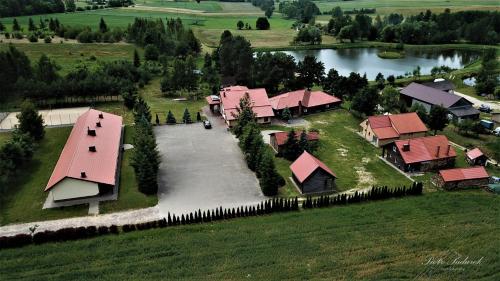an aerial view of a village with a house and a river at Tawerna-Stawiska in Garbatka-Letnisko