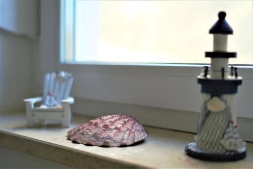 a counter top with a seashell and a lighthouse on it at Villa M - Your business & holiday apartment in Sibenik in Šibenik