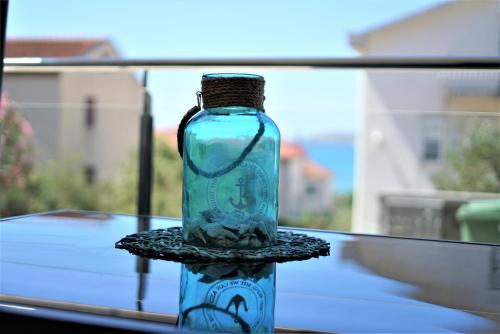 a glass bottle sitting on top of a table at Villa M - Your business & holiday apartment in Sibenik in Šibenik