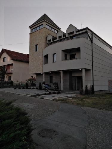 a large building with a tower on top of it at Apartman TiA Vrnjacka Banja in Vrnjačka Banja
