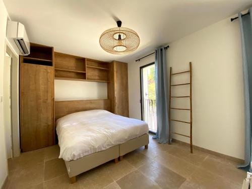 um quarto com uma cama e uma janela em Villa Vintour em Malaucène