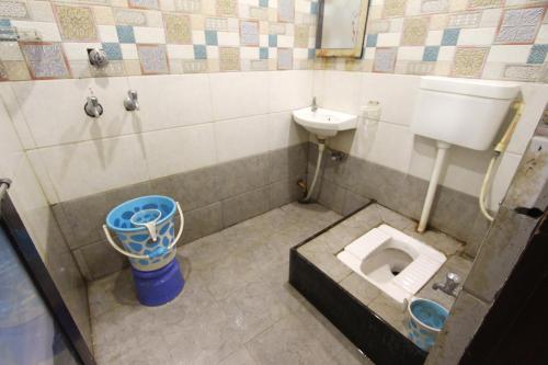 a small bathroom with a toilet and a sink at Hotel Raahat Palace in Ajmer