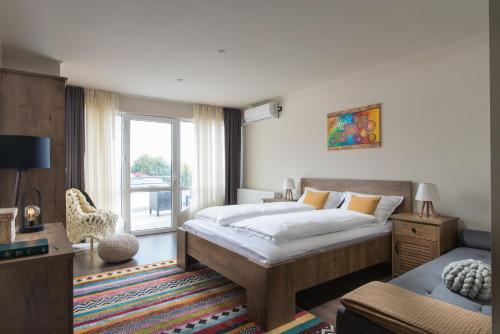 a bedroom with a large bed and a window at Вила Франк/Villa Frank in Enina