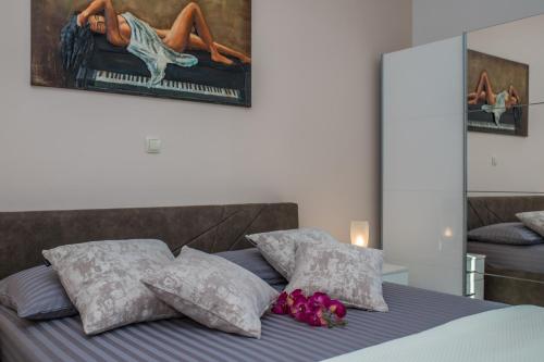 a bedroom with a bed with purple sheets and pillows at Luxury Apartments Tafra in Lokva Rogoznica