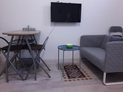 a living room with a couch and a table at Studio apartman Ela in Travnik