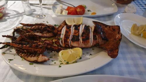 a plate of food with shrimp on a table at Guest House Solive in Himare