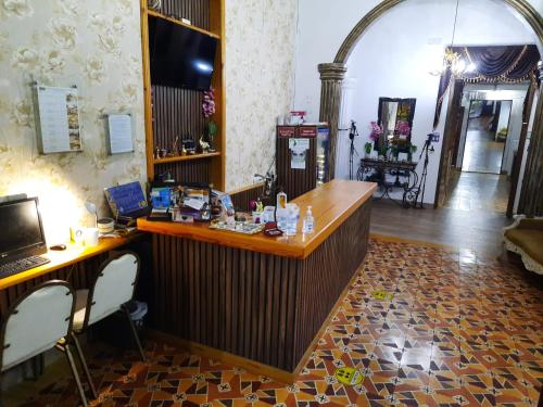 a room with a bar with a desk in it at Jardín Del Duque Hotel Boutique in Santa Marta