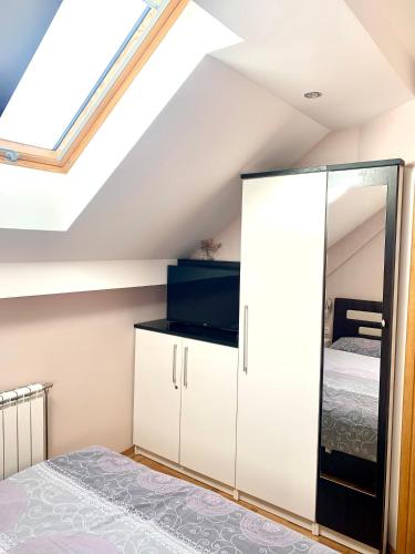 a bedroom with a bed and a skylight at Oaza in Zlatibor