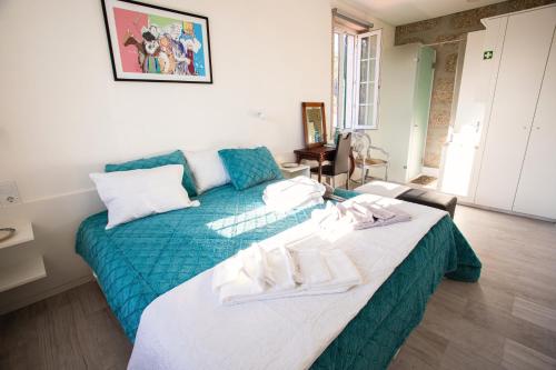 a bedroom with a bed with towels on it at Fonte Velha in Castelões- Penafiel