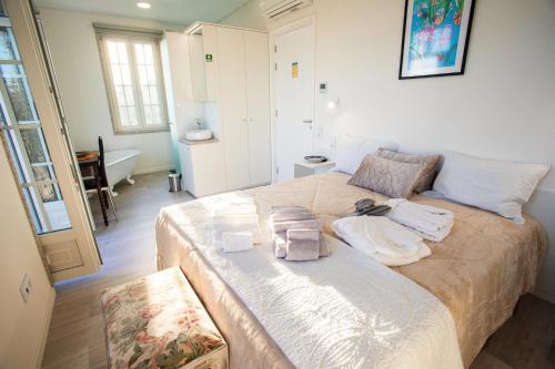 a bedroom with a large bed with towels on it at Fonte Velha in Castelões- Penafiel