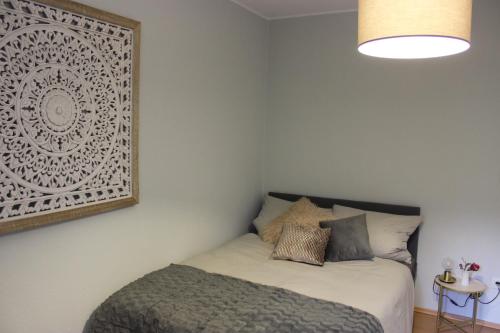 a bedroom with a bed and a picture on the wall at Ferienapartment Helling in Bad Sobernheim