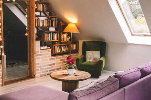 a living room with a couch and a table at Pannónia Apartment in Göd