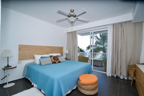 a bedroom with a blue bed and a balcony at Vista Mare Samana Amazing Views!! in Santa Bárbara de Samaná