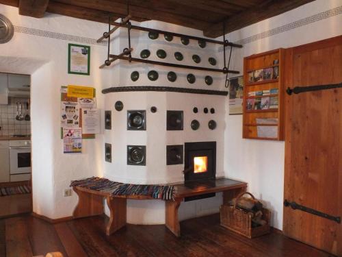 a room with a fireplace and a table with a fire at Ferienhaus "Zur alten Schmiede" in Mariahof
