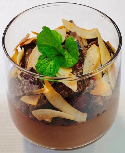 a glass bowl of food with a green leaf on top at Cotswold Gardens in Armidale