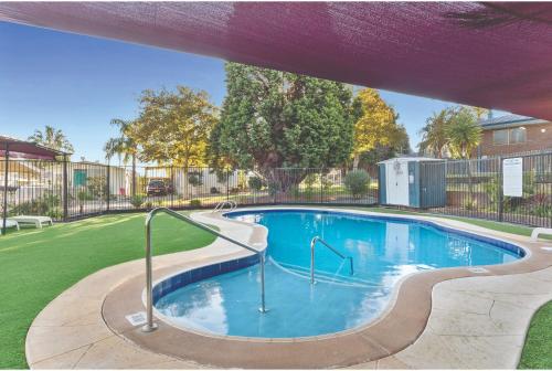 a swimming pool with a slide in a yard at Discovery Parks - Swan Valley in Caversham