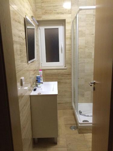 a small bathroom with a sink and a shower at Casa São Bartolomeu - 5 Quartos com Piscina in São Bartolomeu