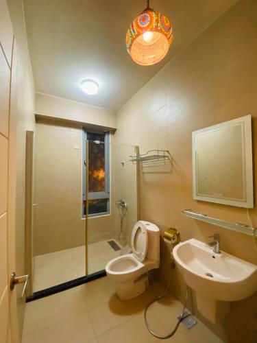a bathroom with a shower and a toilet and a sink at Caiyan Homestay in Hualien City