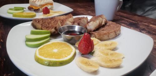 a plate of food with bananas and fruit on a table at Los Portones de Ataco in Concepción de Ataco