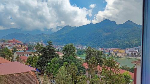 a view of a town with a river and mountains at Venus Sapa Hostel in Sa Pa
