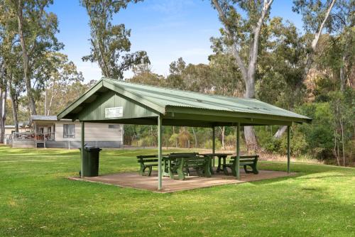 a picnic shelter with picnic tables in a park at Discovery Parks - Clare in Clare