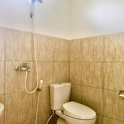 a bathroom with a toilet and a shower at Karimunjannah House in Karimunjawa