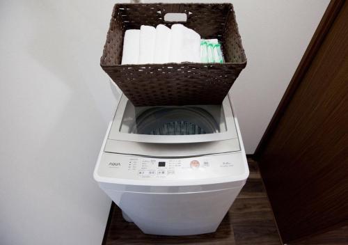a washing machine with a basket on top of it at Station Villa Plaisir Mt. Fuji in Fujikawaguchiko